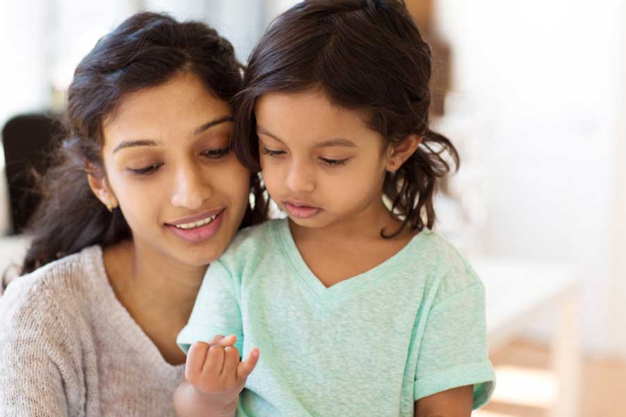 Toddler and her mother practice counting on fingers.