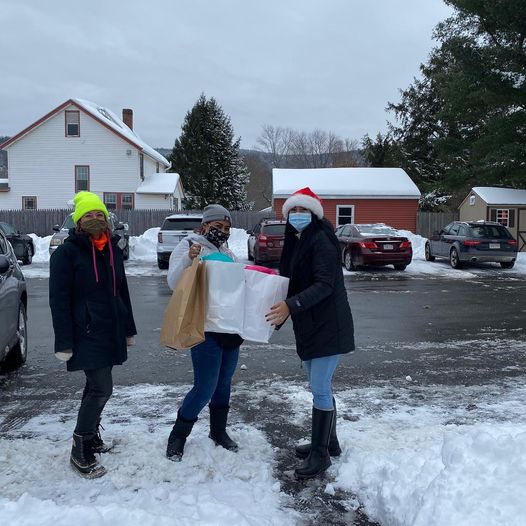 An image of community members promoting a winter clothes drive for families in need.