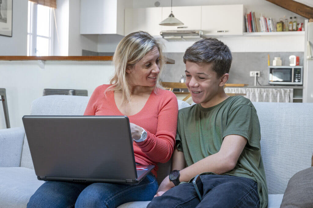 Woman and boy looking at a laptop